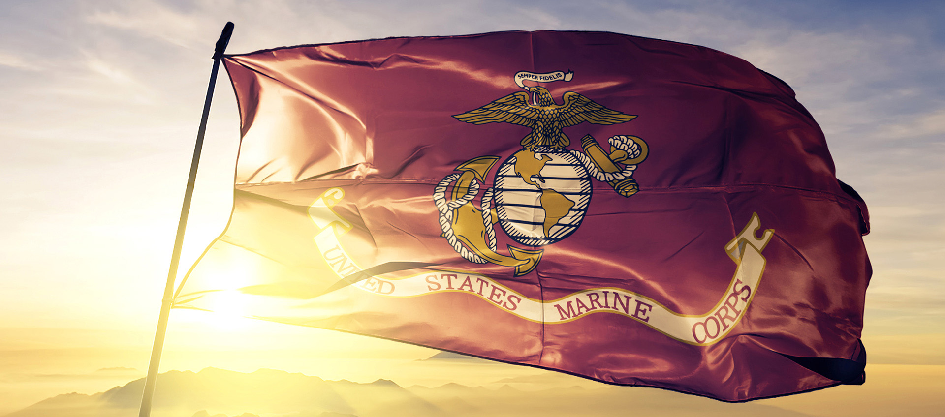 United States Marine Corps flag textile cloth fabric waving on the top sunrise mist fog