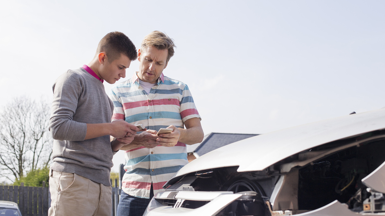 Men exchanging car insurance information after an accident 