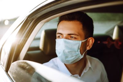 Car passager not wearing a seatbelt looking out the window